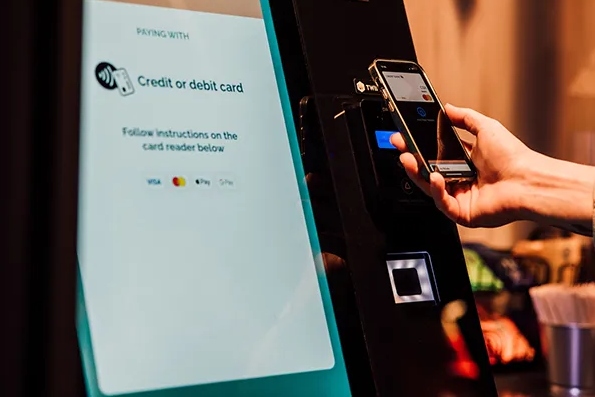 Person using a REALFAST vending machine with contactless payment
